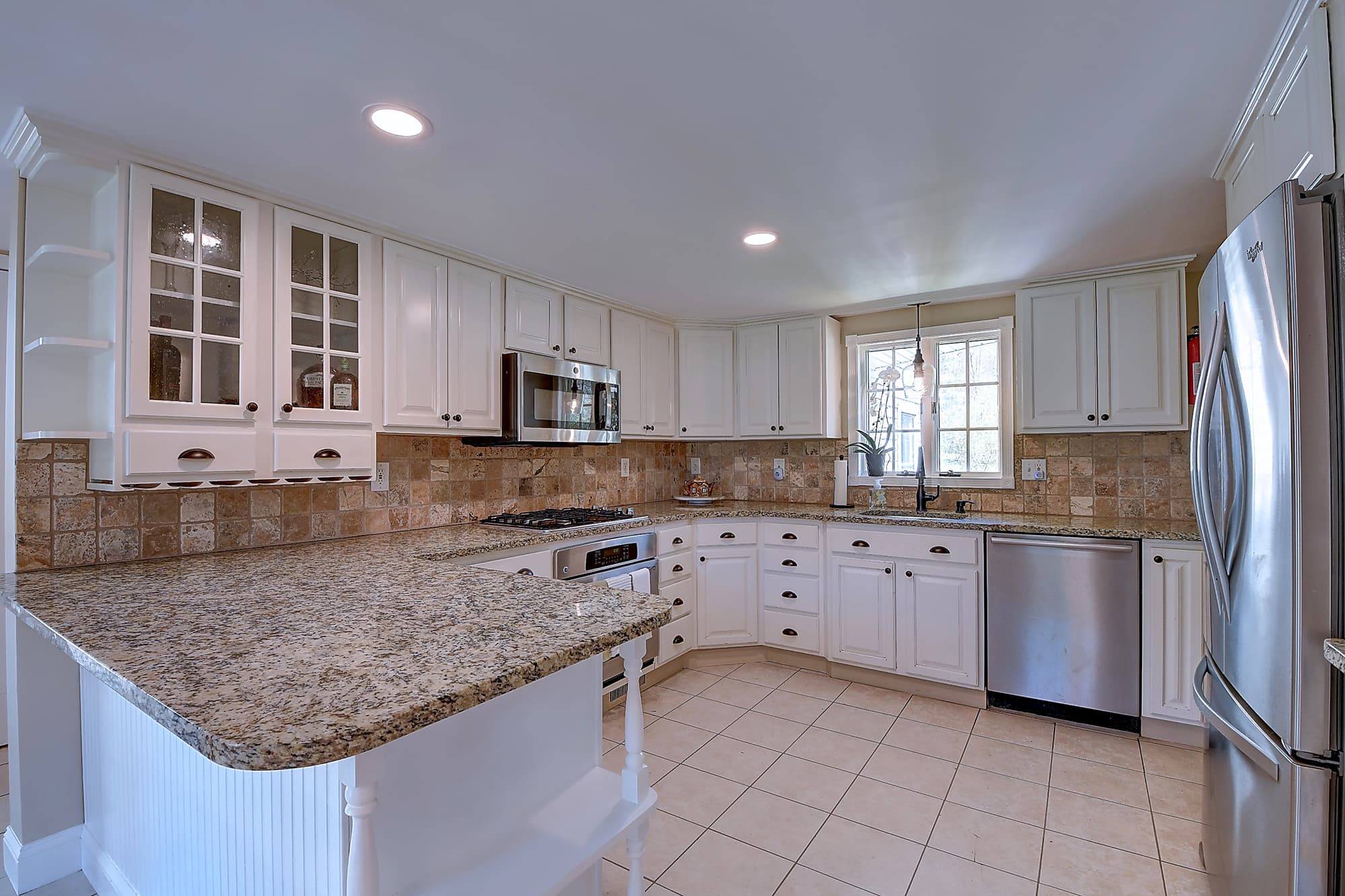 Kitchen with stainless appliances and granite island