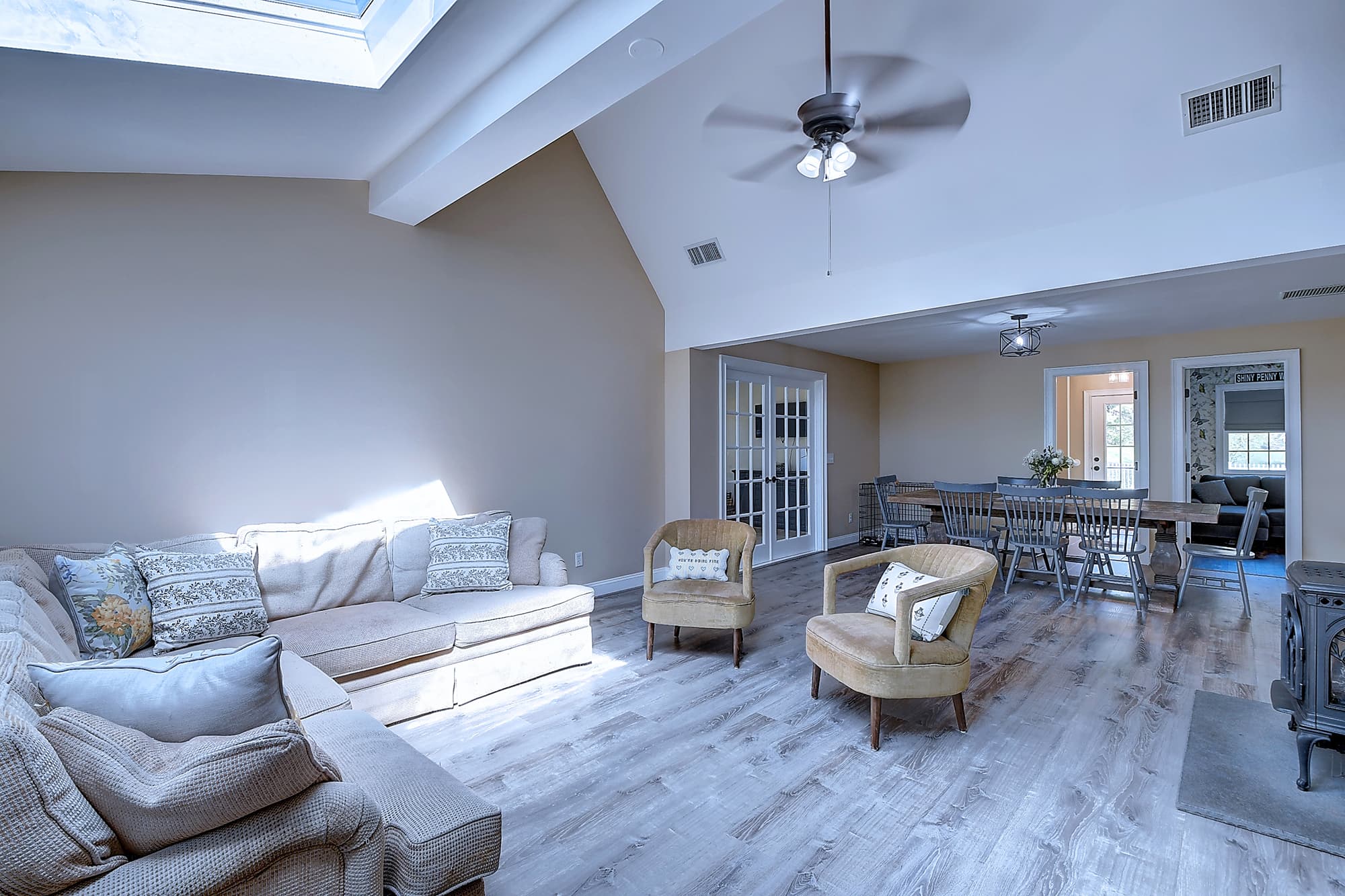 Sun-filled vaulted living space opening to dining area