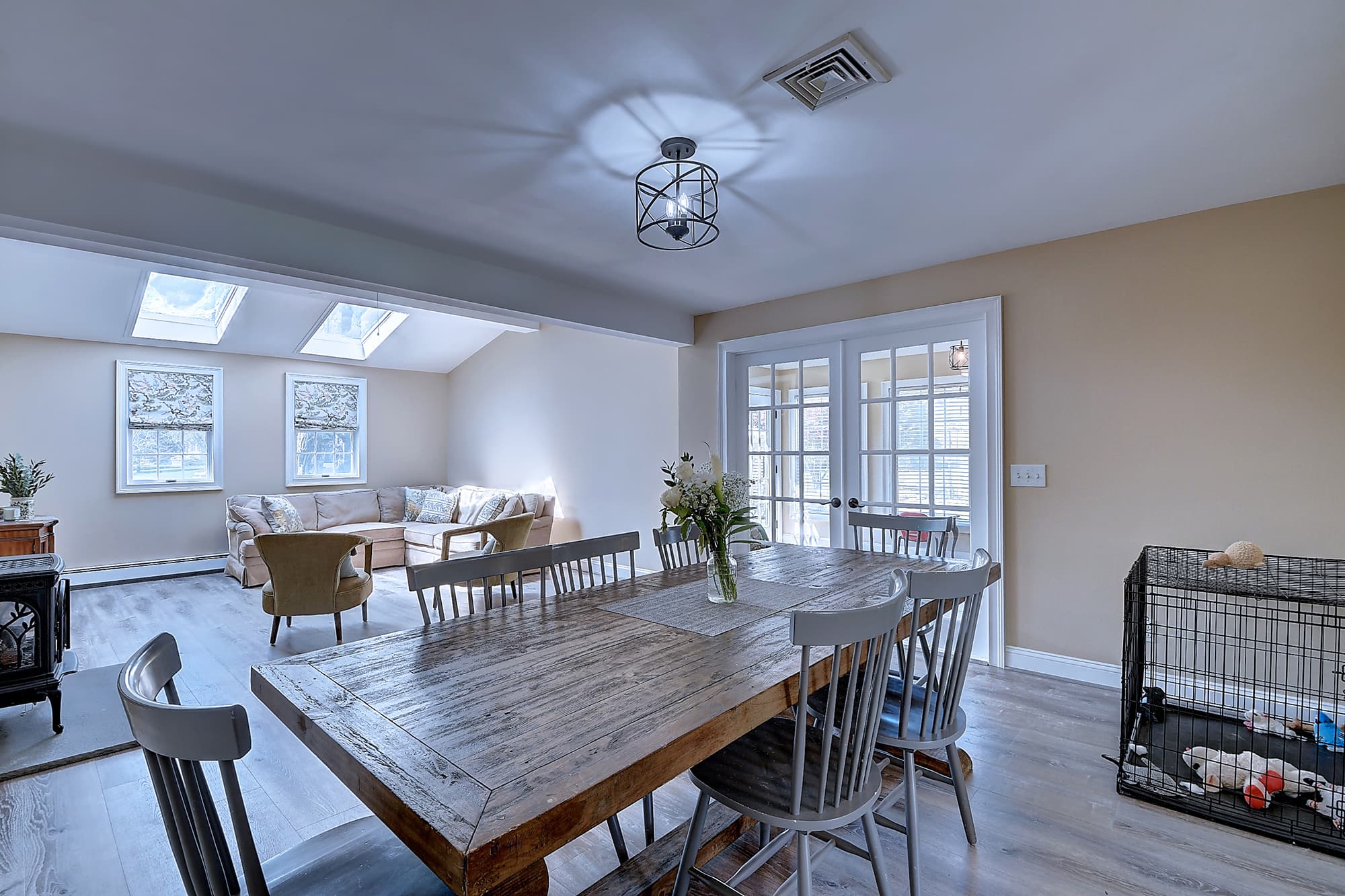 Dining area beneath skylights with adjacent sitting space