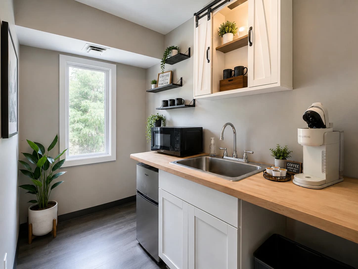Conceptual shared kitchenette with sink, microwave, mini refrigerator, and coffee station