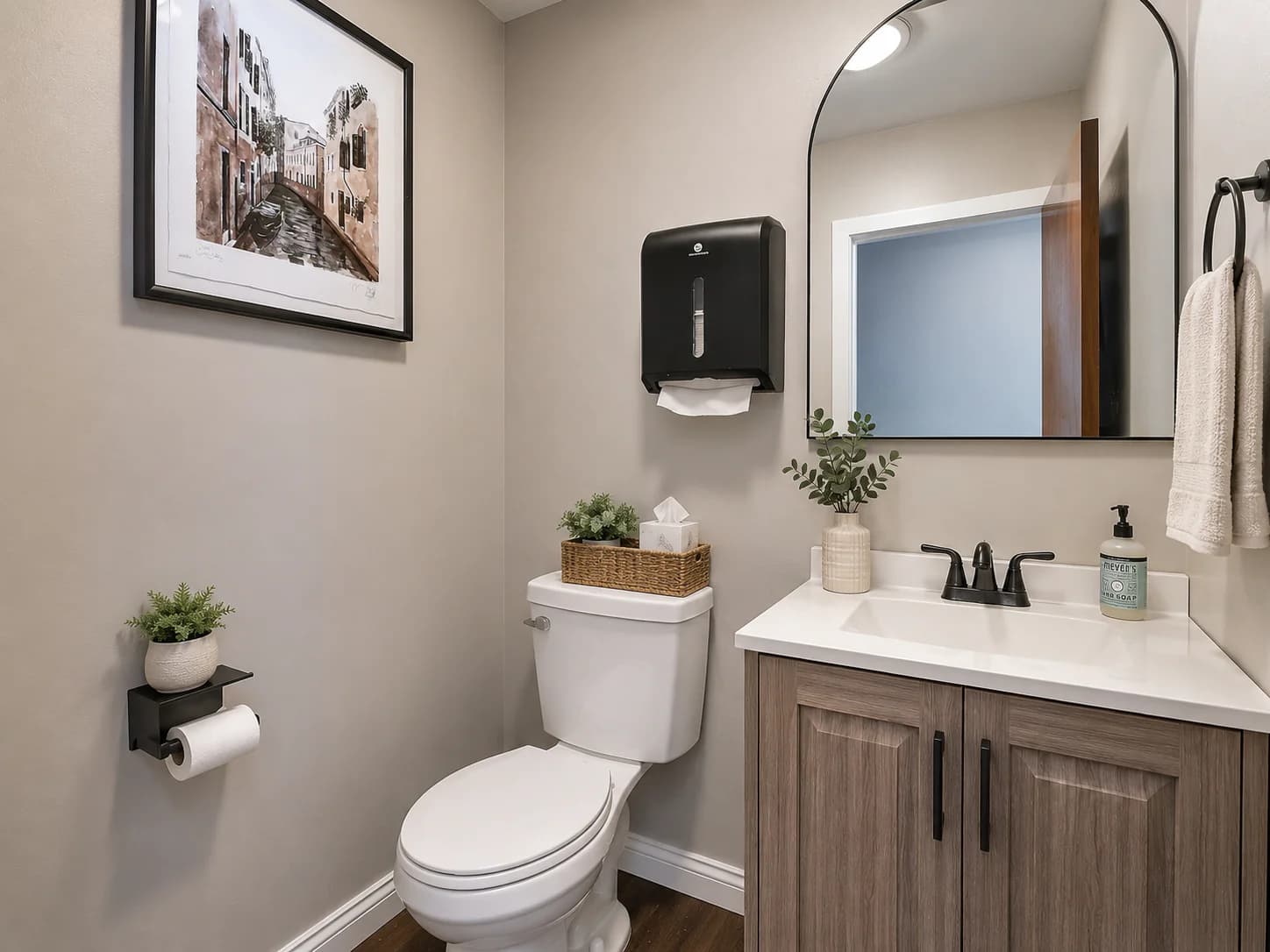 Conceptual shared restroom staging with vanity and neutral finishes