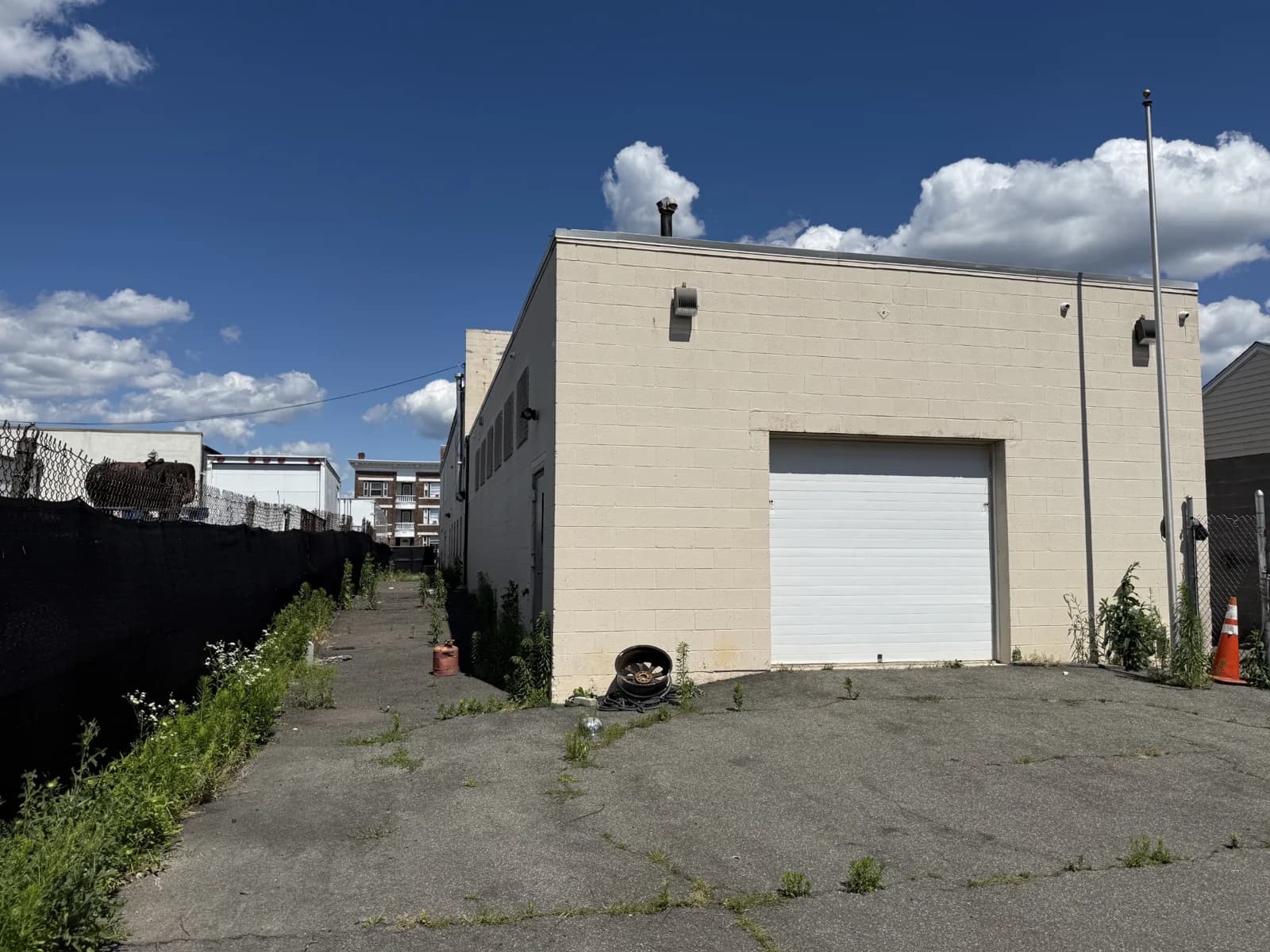 Existing rear exterior and overhead garage bay at 461 Wethersfield Avenue in Hartford